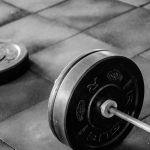 black barbell on tile flooring