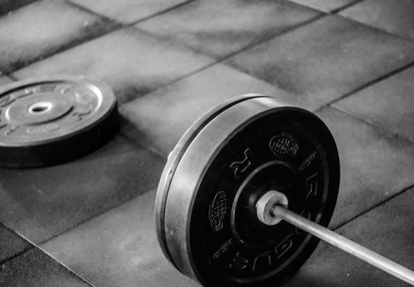 black barbell on tile flooring